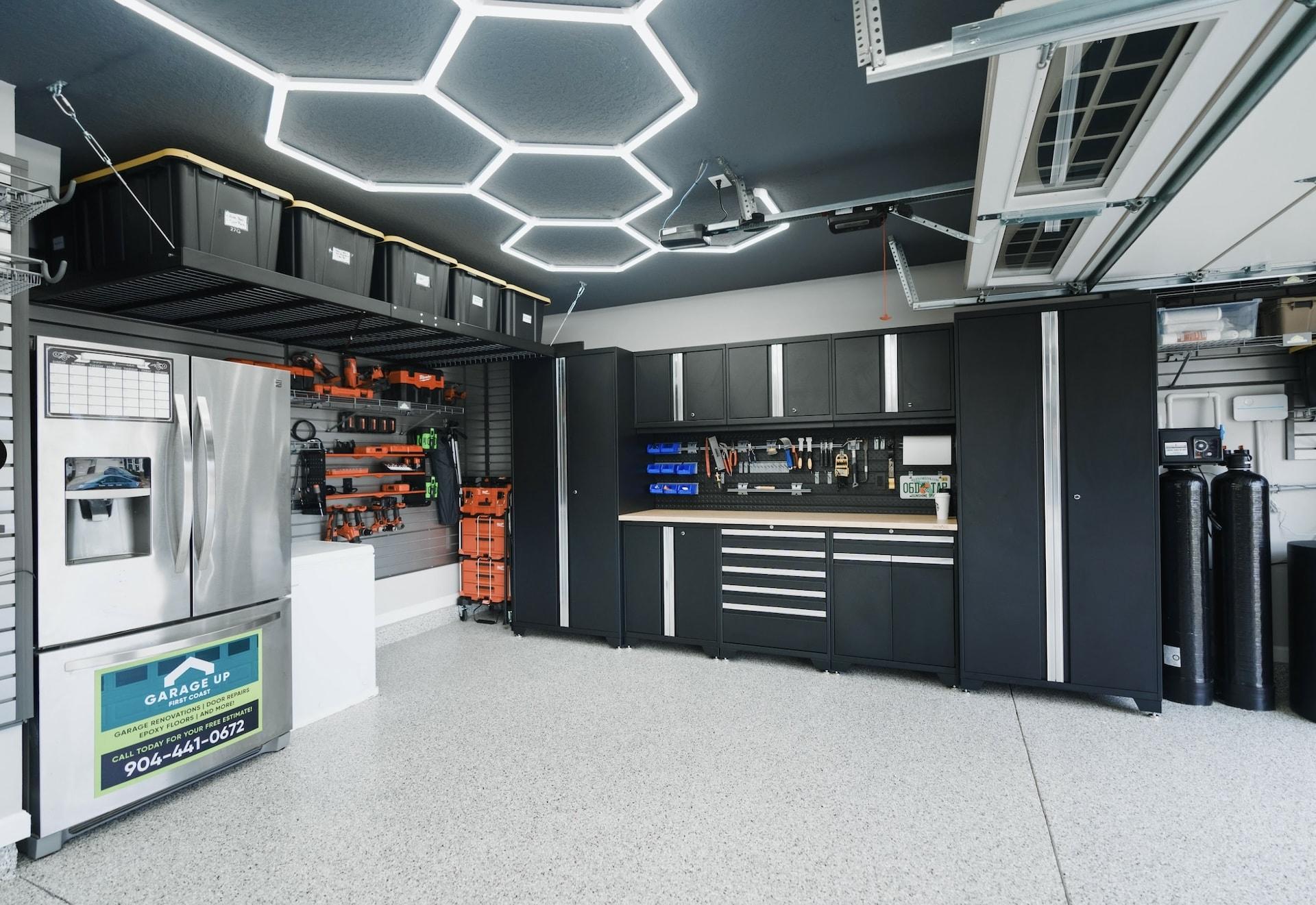 Premium garage with hexagonal lighting and cabinetry