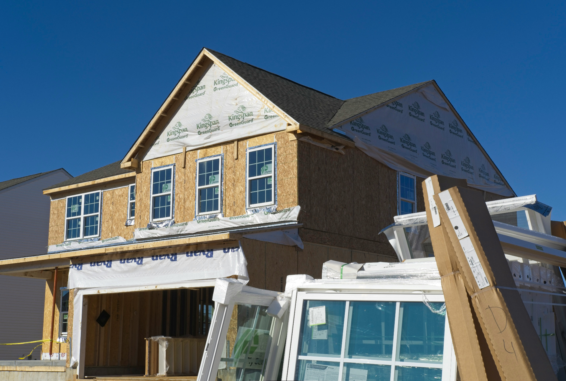 New home under construction with sheathing and framing